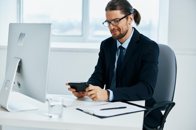 Man in a suit work in front of a computer documents Lifestyle High quality photo