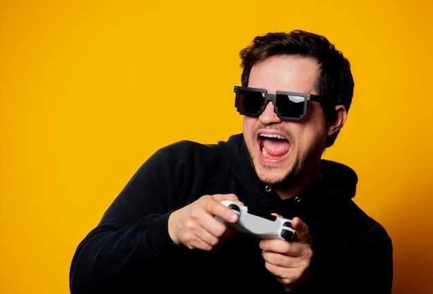 Man sunglasses plays with a joystick