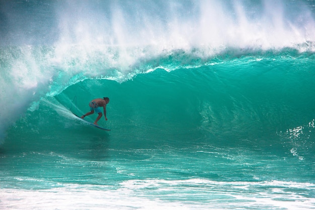 Man surfing in sea against sky