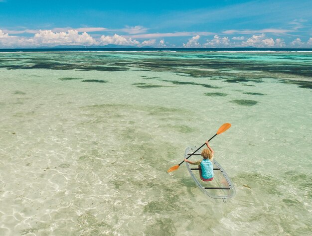 Man surfing in sea against sky