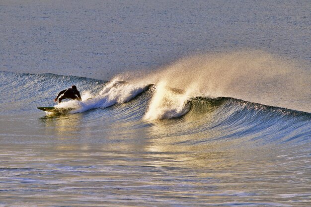 Foto uomo che fa surf in mare