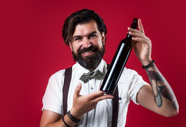 Man in suspenders and bow tie choosing a wine bottle best\
quality