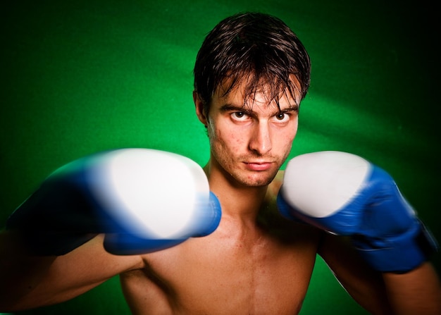 Man sweating all over in boxing gloves...