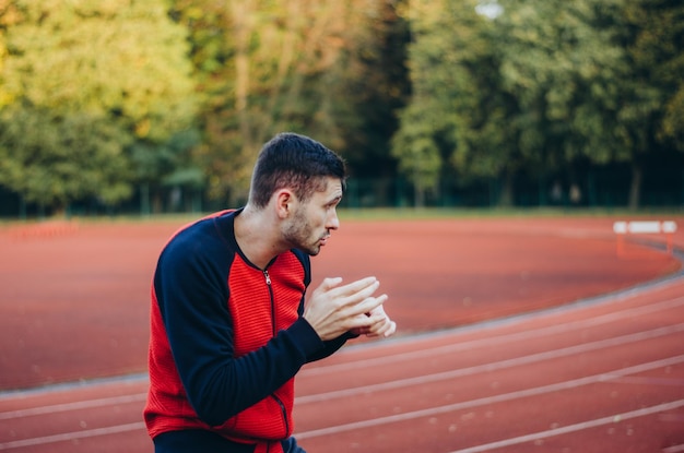 a man in a sweatshirt boxing alone