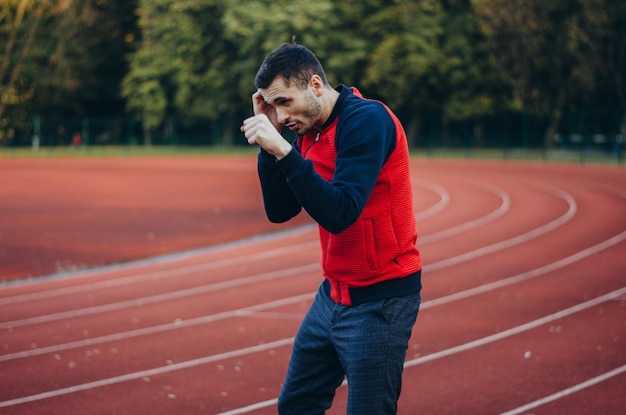 a man in a sweatshirt boxing alone