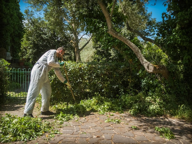 Man sweeps with an iron broom