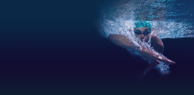 Man swimming in deep blue water