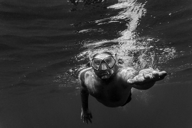 Man swimming underwater in sea