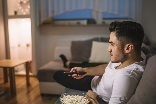 Man switching channels on TV