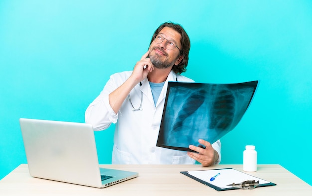 man on table over isolated blue background