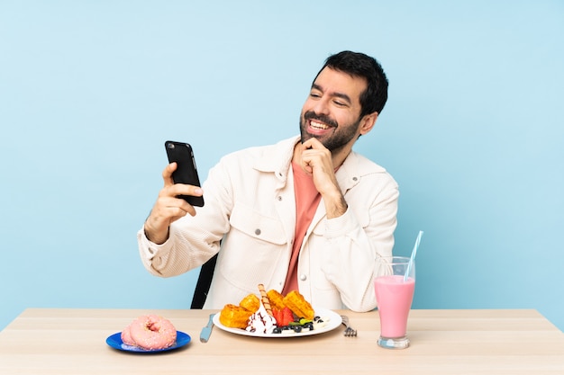 Man in a table with waffles