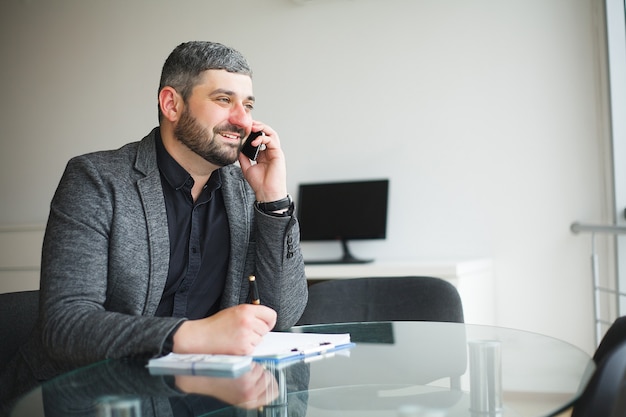 Man takes bribe for signing the contract and talks on the phone