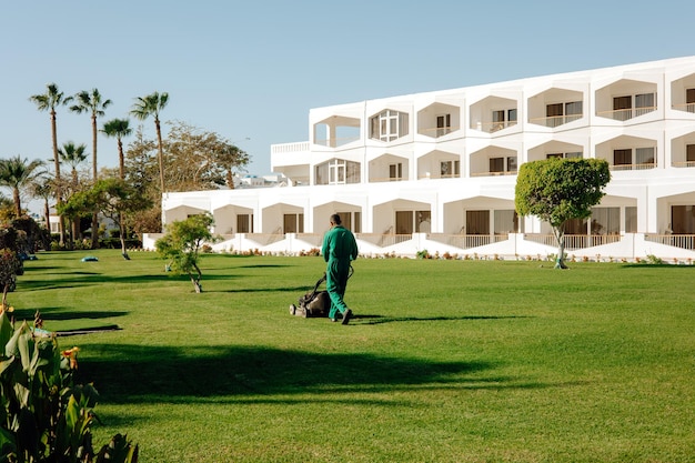 A man takes care of the hotel lawn