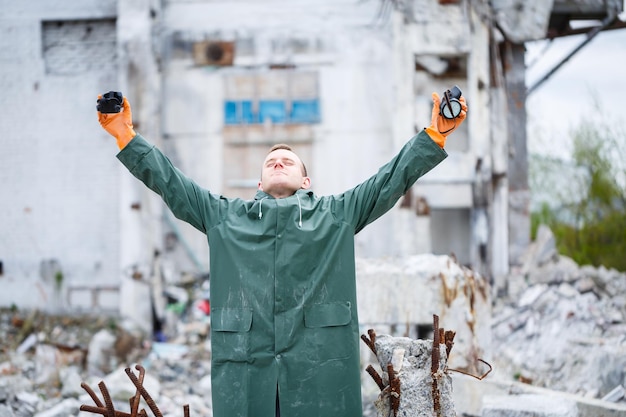 A man takes off a protective mask and he is dressed in protective clothing explores a dangerous radioactive zone