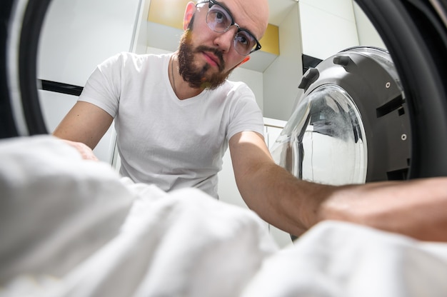 Man takes out the inside of a washing machine