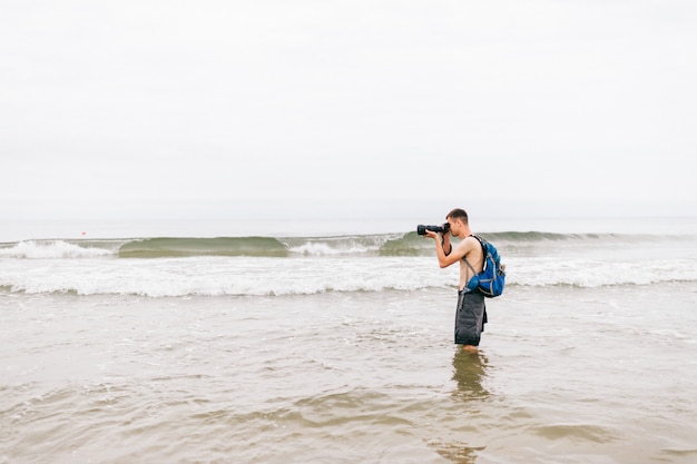 Man takes pictures at the beach