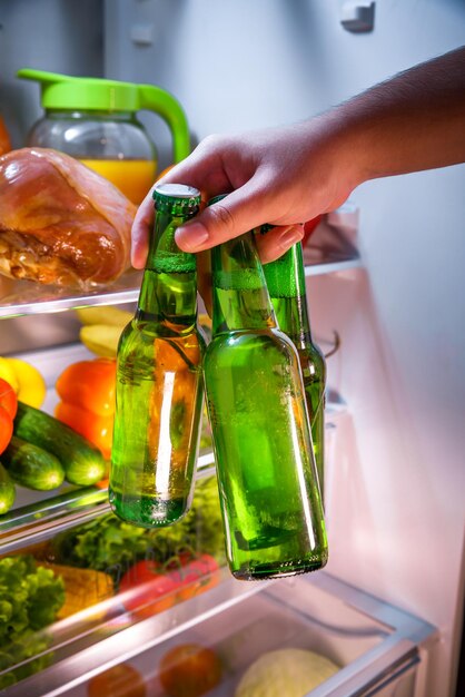 Man taking beer from a fridge