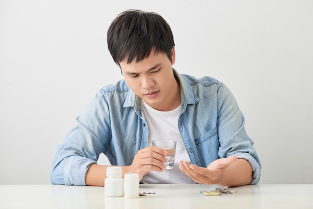 Man taking his pills on couch in the living room