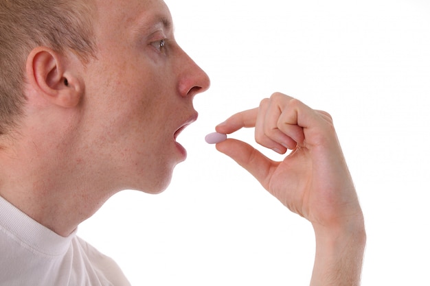 Man taking medication. Close-up.