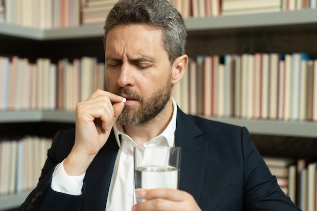 Man taking a medicine pill from headache migraine