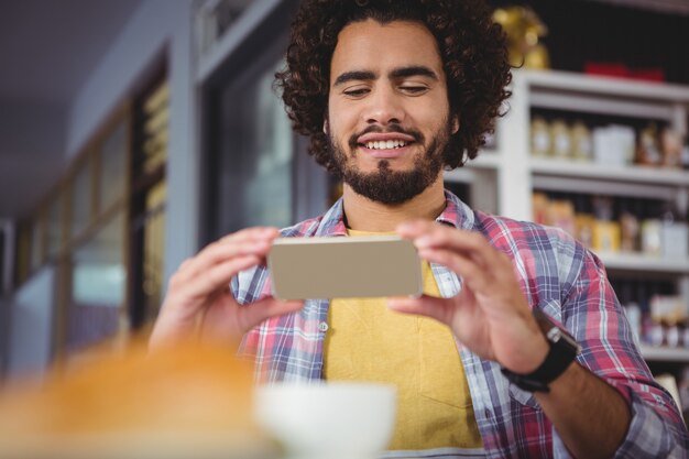 Man taking photograph of coffee