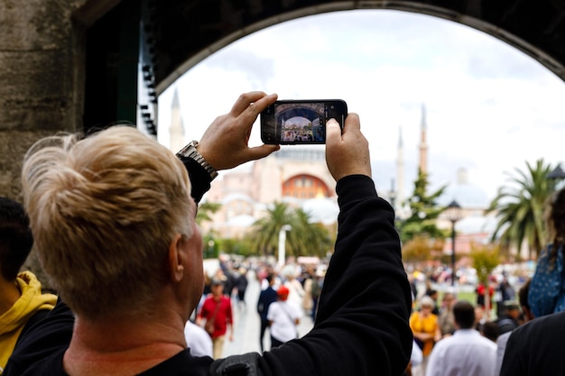 Man taking a picture of a islamic city