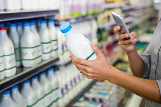 Man taking picture of some milk