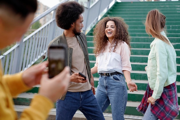 Man taking pictures of his dancing friends