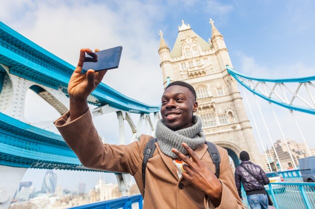 タワーブリッジとロンドンでselfieを取っている人