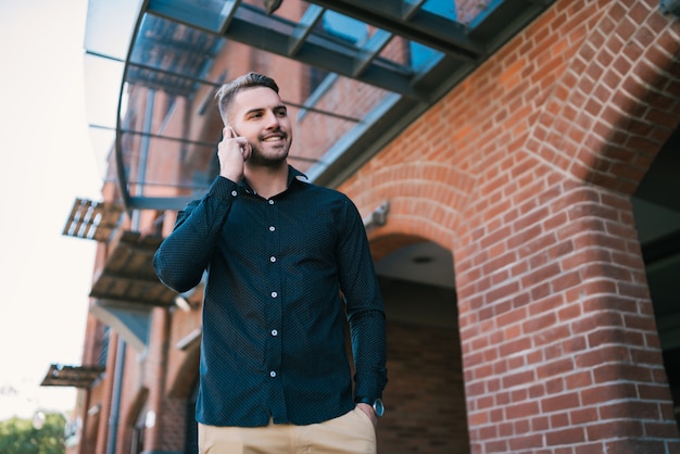 Man talking on the phone outdoors.