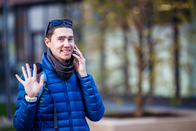 Man talking on phone and waving his hand