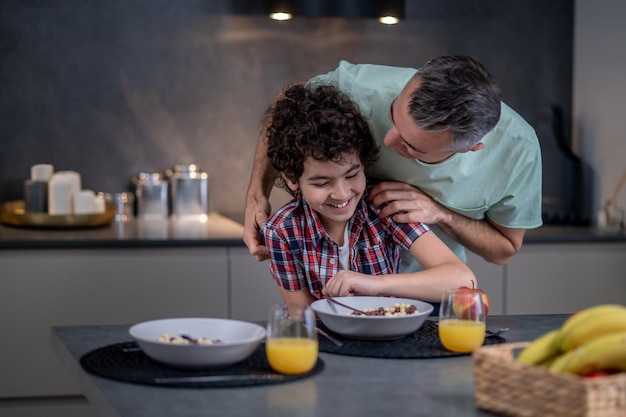 Man talking with his son in playful mood