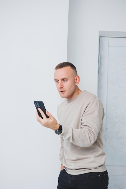 A man talks emotionally on the phone and waves his hands The man solves the problem over the phone Remote work