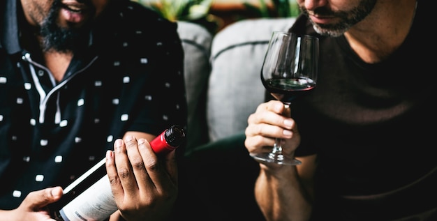 Man tasting red wine with friends