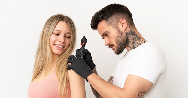 Man tattooing a girl over isolated background