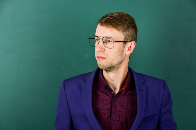 Man teacher wear eyeglasses for vision green chalkboard background career in education concept