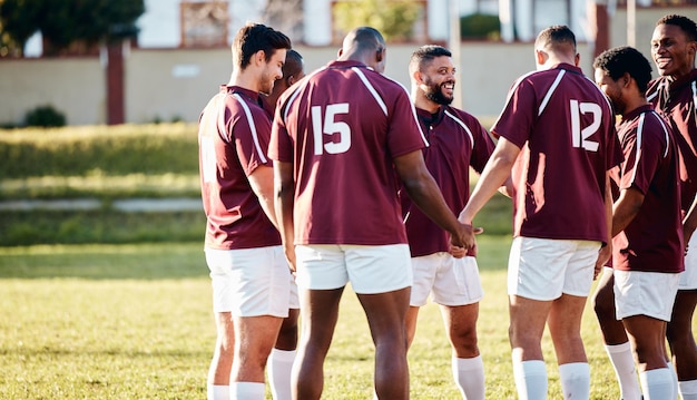 Photo man team and holding hands on grass field for sports motivation coordination or collaboration outdoors group of sport players in huddle for fitness training goal or strategy together for game