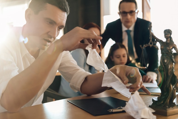 Man tears up marriage contract while sitting next to woman