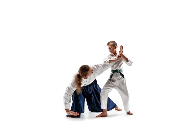 Man and teen boy fighting at aikido training in martial arts school