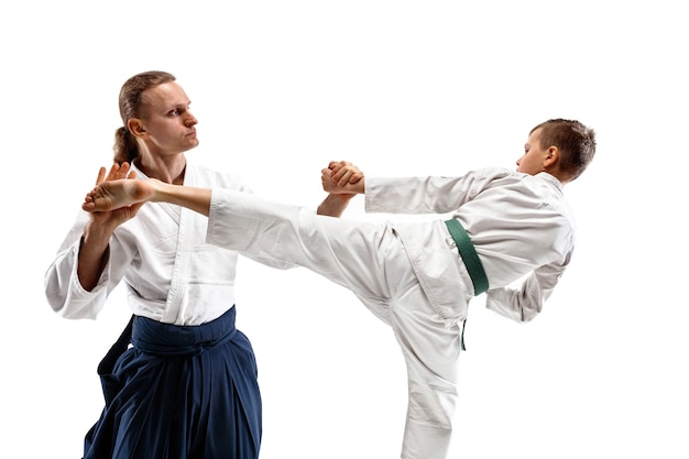 Photo man and teen boy fighting at aikido training in martial arts school