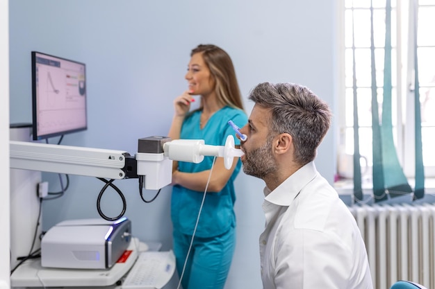 Man testing breathing function by spirometry Diagnosis of respiratory function in pulmonary disease