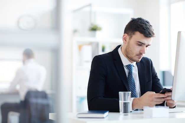 Man texting by workplace