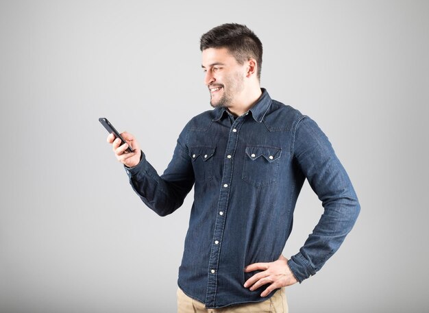 Man texting message isolated on gray