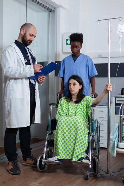 Man therapist doctor writing medical expertise on clipboard\
working hospital ward