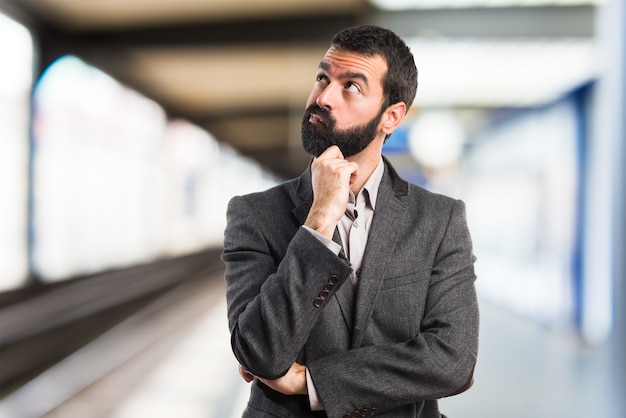 Man thinking on unfocused background