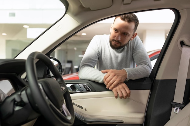 The man thought about buying a new car and an insurance policy