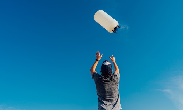 Man throwing a plastic bottles