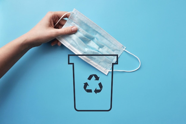 A man throws away a medical mask. A symbol of the end of the pandemic