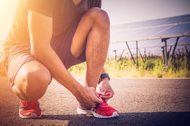 Man tie his shoes for jogging