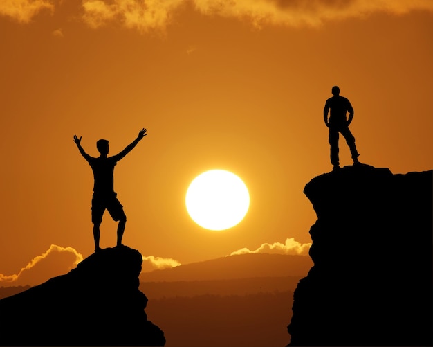 Man on top of mountain during and big sun